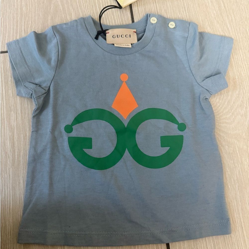 Brand new Gucci Kids Light Blue Tee with Green and Orange Design